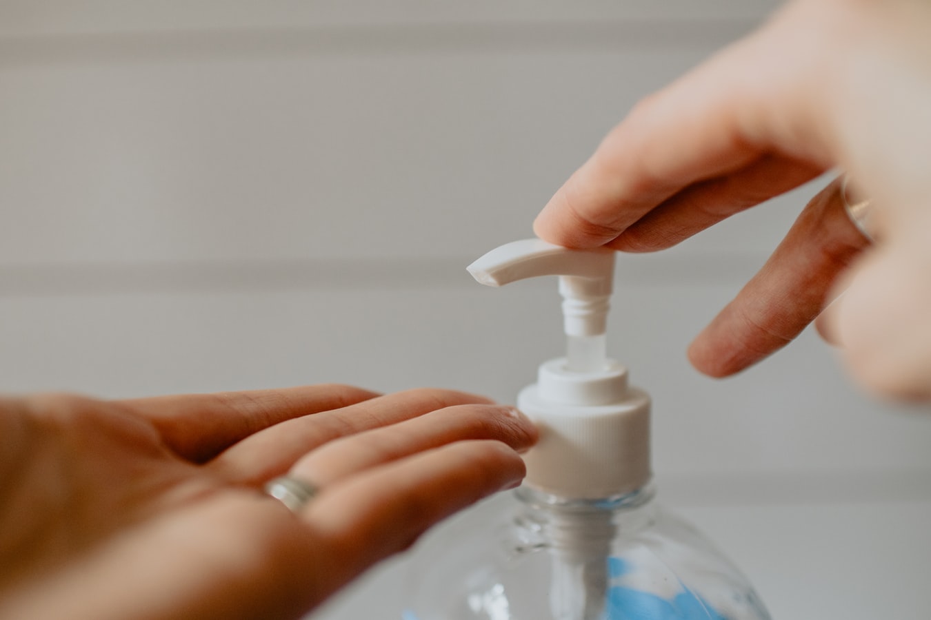 hand sanitizer being squeezed into someone elses hand